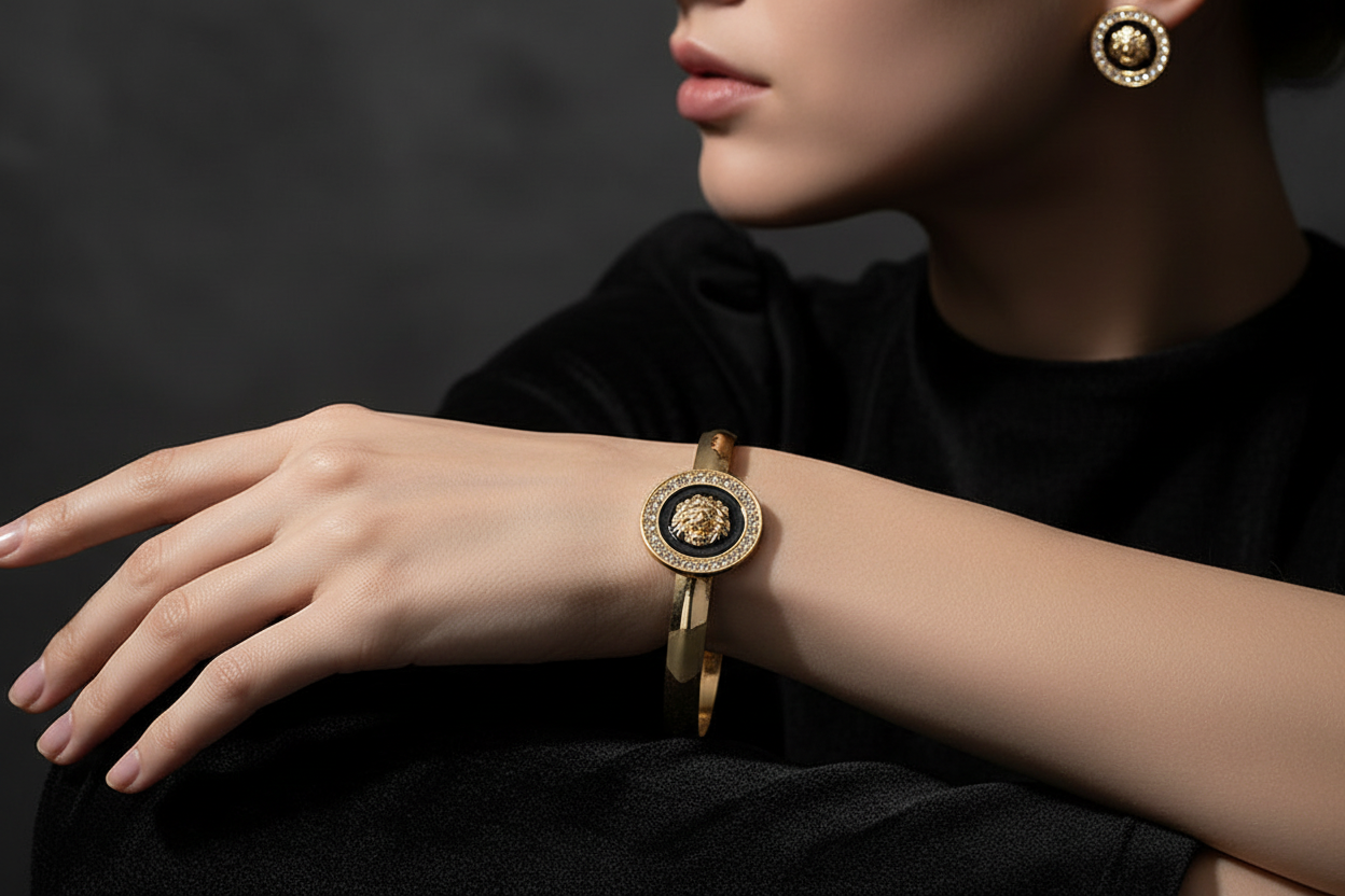 Model wrist with lion bangle and earrings
